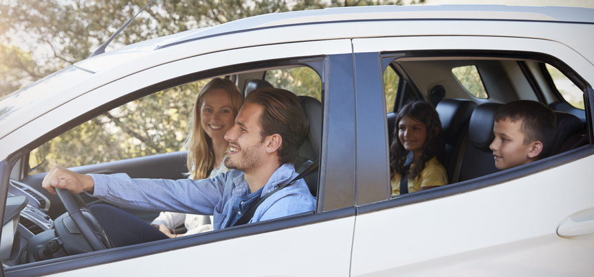 Family with two children driving in new lease