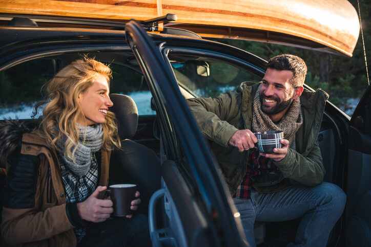 Couple discussing used car lease over coffee