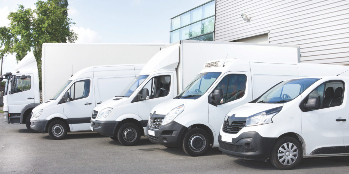 Row of fleet lease vans and a box truck